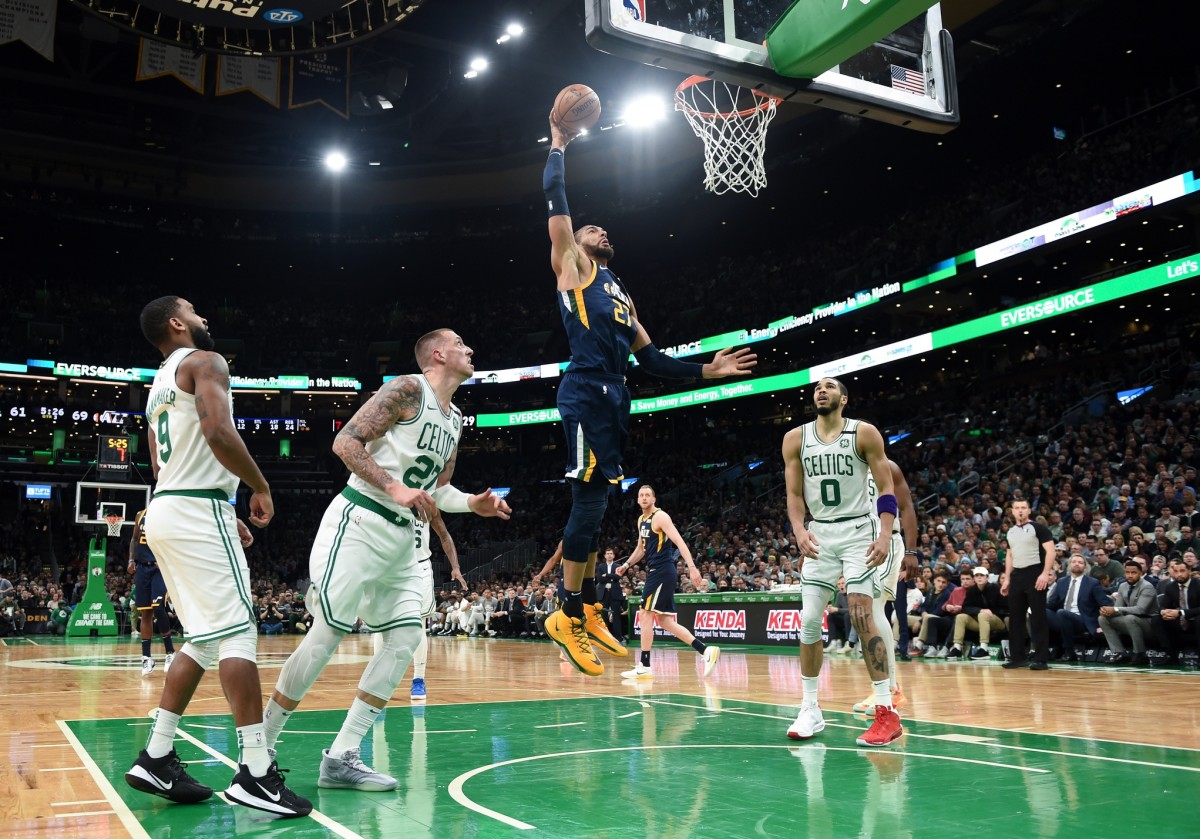 Rudy Gobert (27) dunks over Jayson Tatum (0) in a game against the Boston Celtics